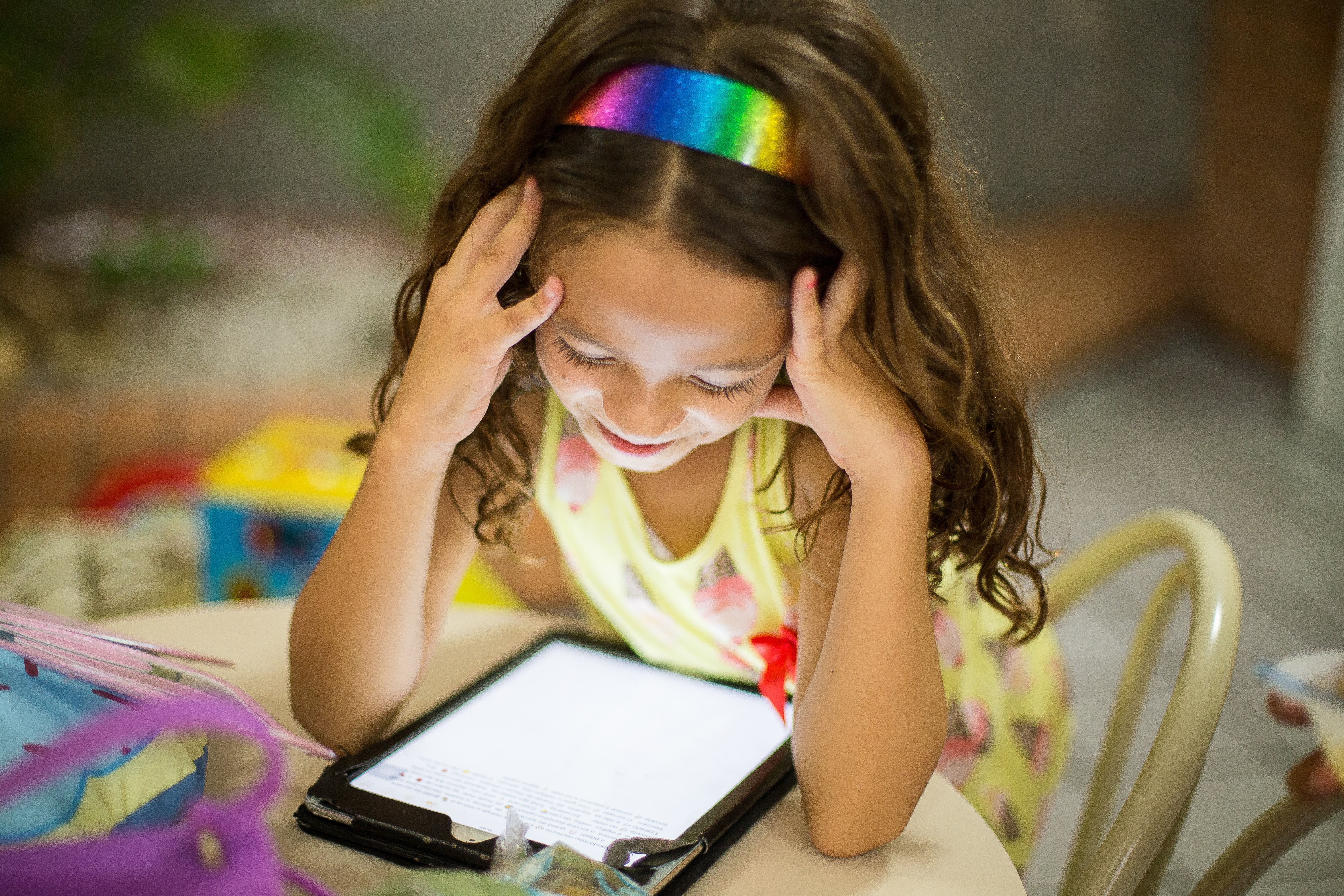  imagem de uma criança lendo em um tablet. 